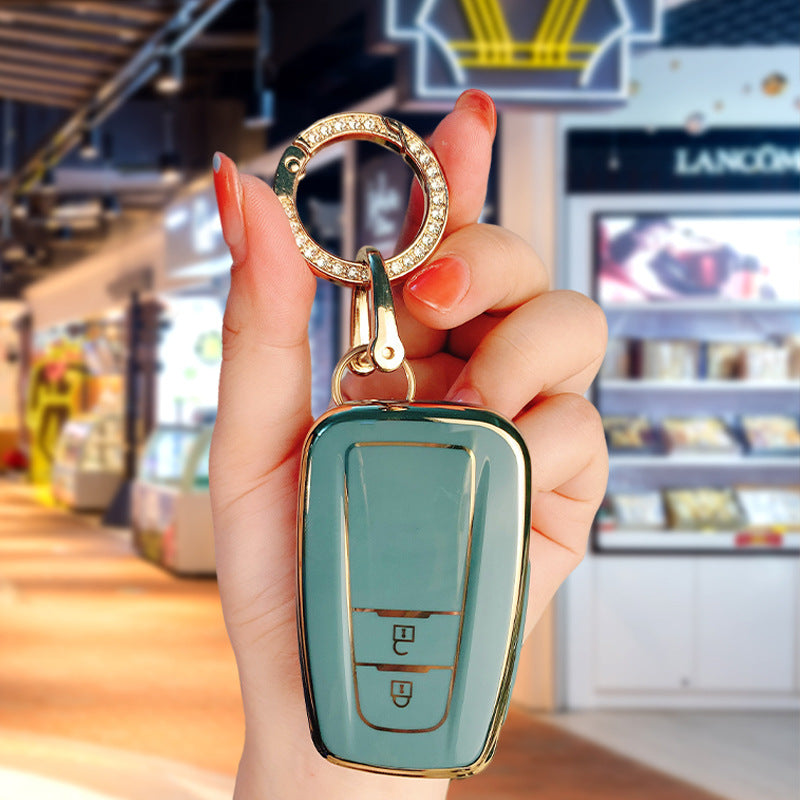 Key fob cover for Toyota 2-button keys – TPU – sage green cover held with crystal keyring close-up