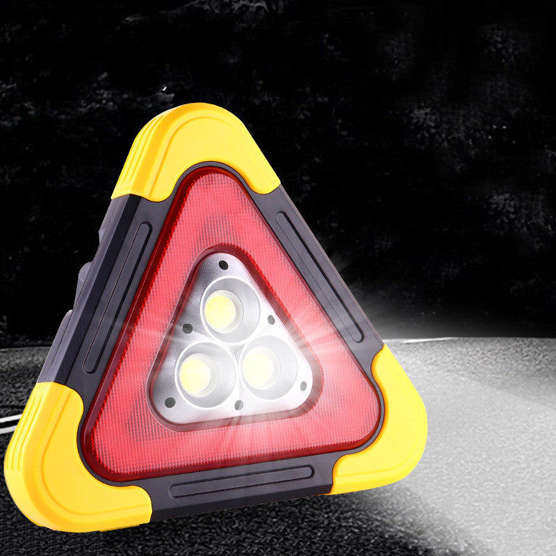 Folding tripod car warning triangle – lit up at night on a roadside