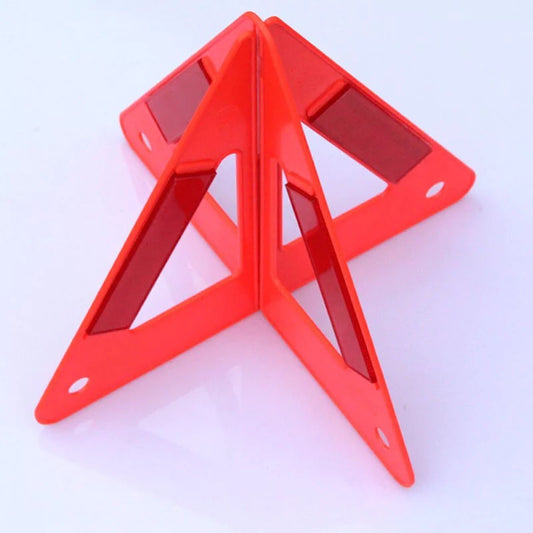 Warning triangle – foldable, reflective – folded triangle standing on a white surface