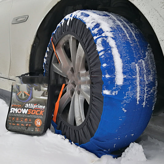 Textile snow sock for car tyres – fitted on a car wheel in snow with packaging