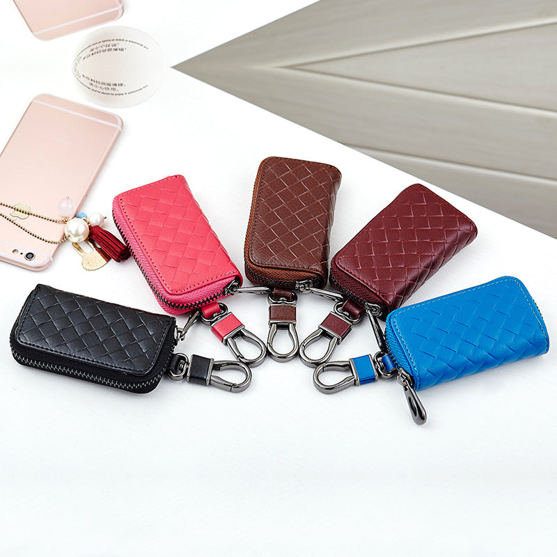 Woven leather car key holder – six colour variants laid out with phone and accessories