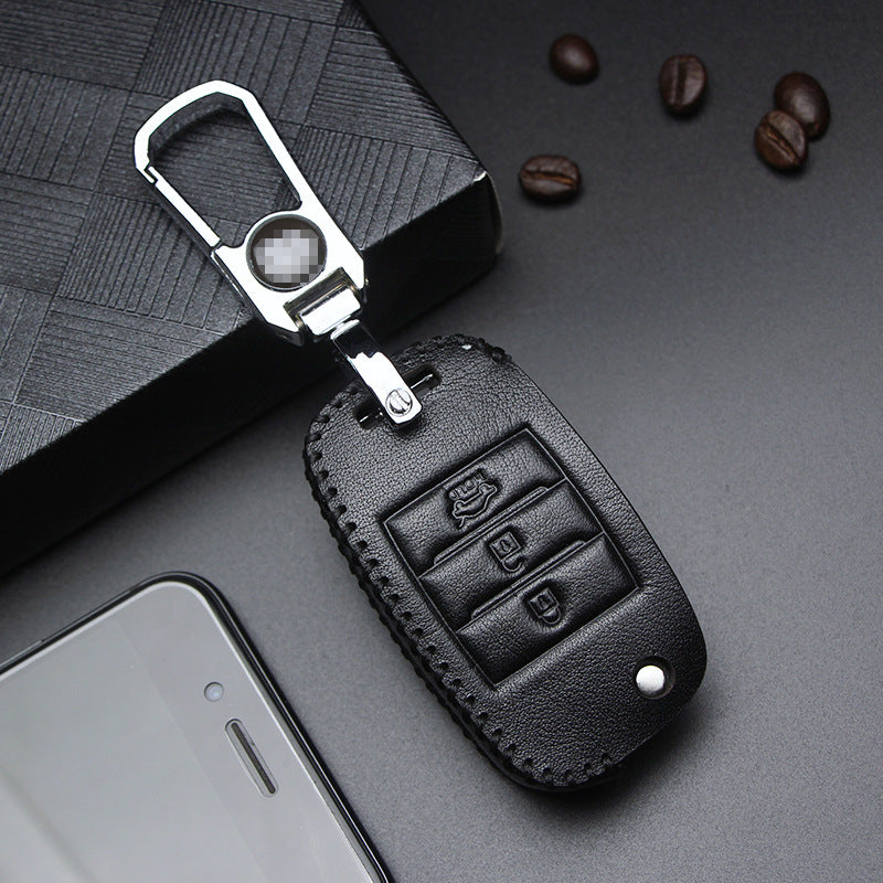 Key fob case for Kia smart & folding keys – genuine leather – black leather case with keyring and smartphone nearby