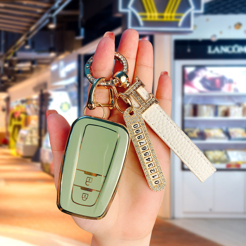 Key fob cover for Toyota 2-button keys – TPU – sage green cover held with crystal keyring and white leather wrist strap